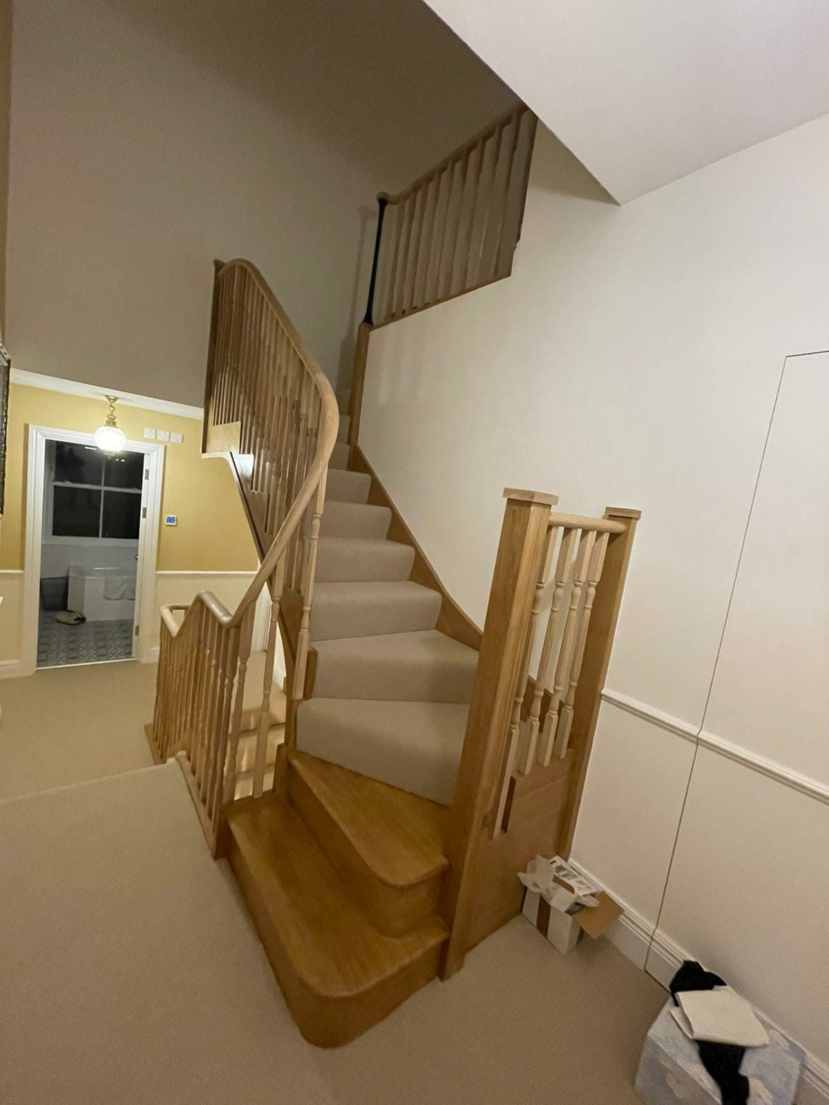 Oak staircase with a carpet runner and turned balusters