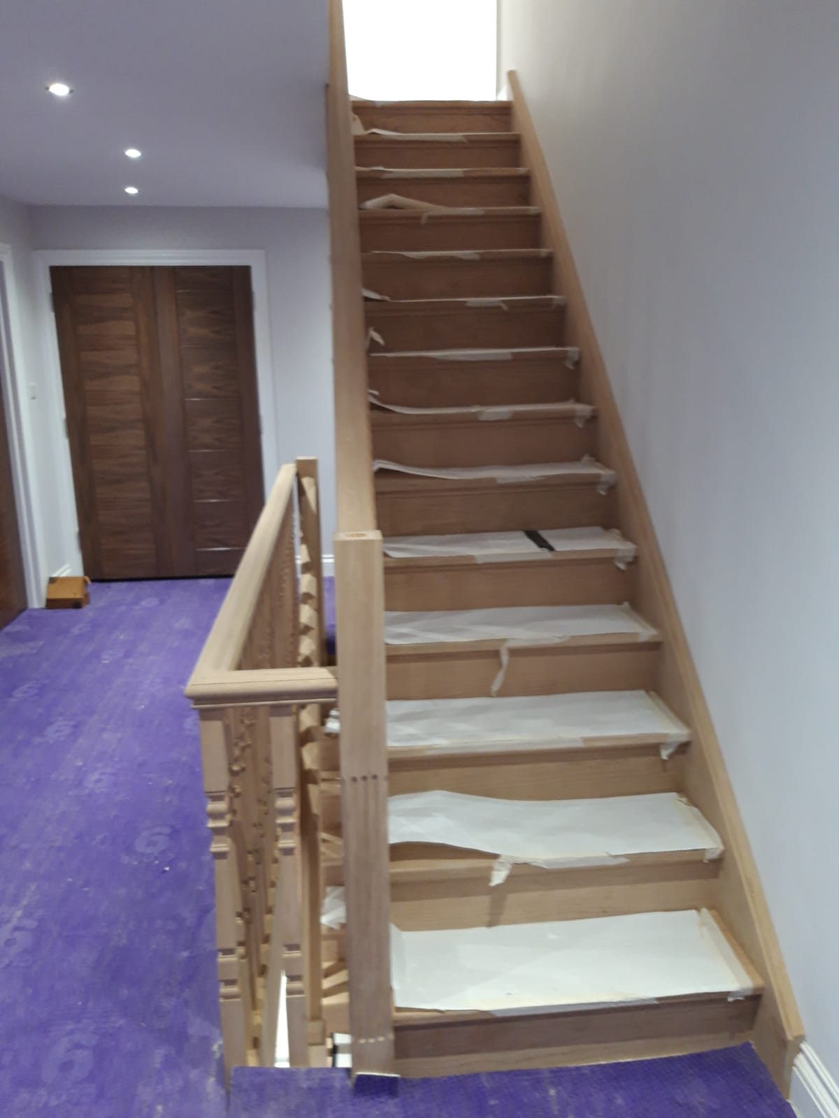 Oak staircase and balustrade, treads still protected