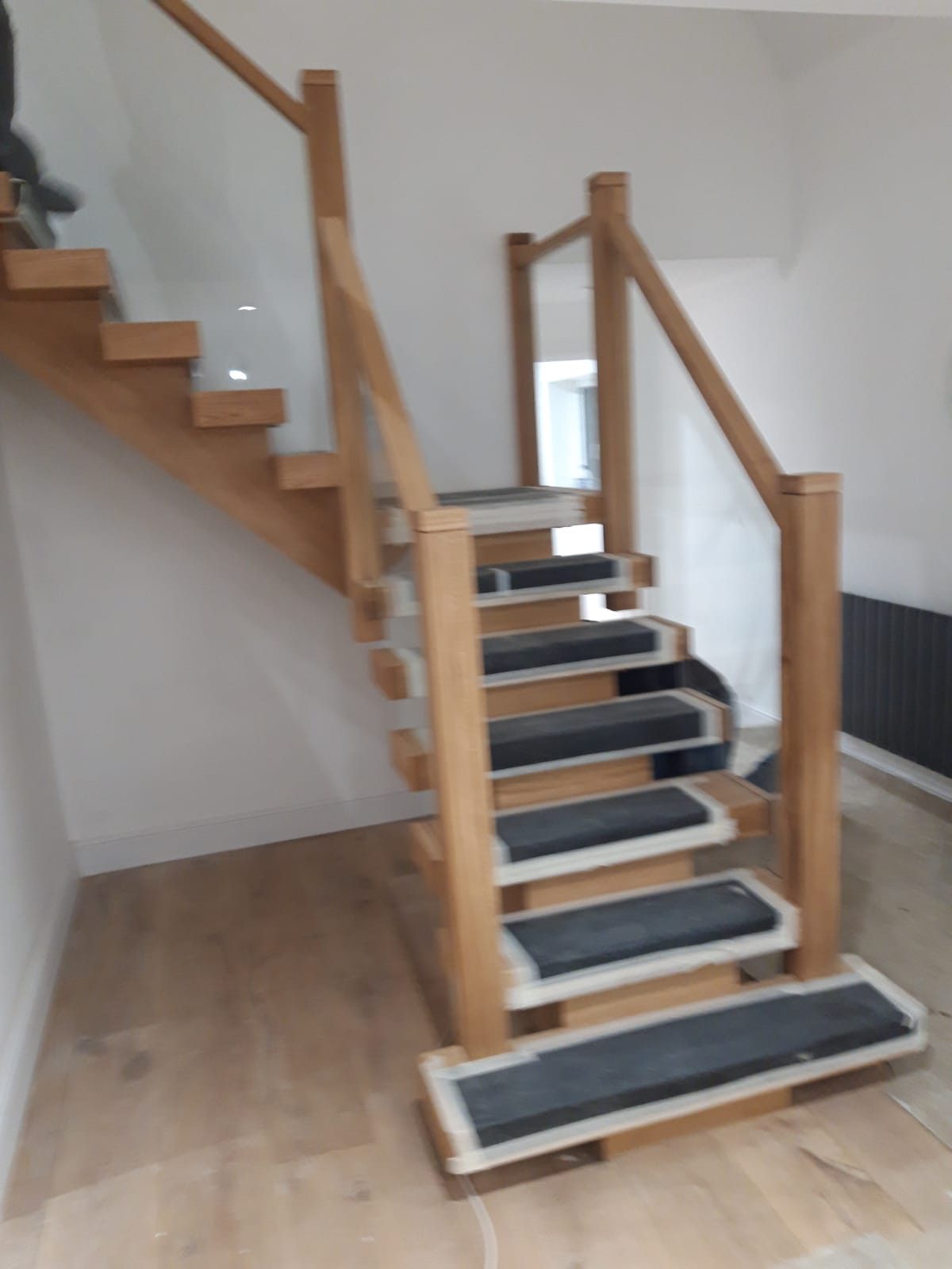 Oak staircase with glass panels and dark tread inserts