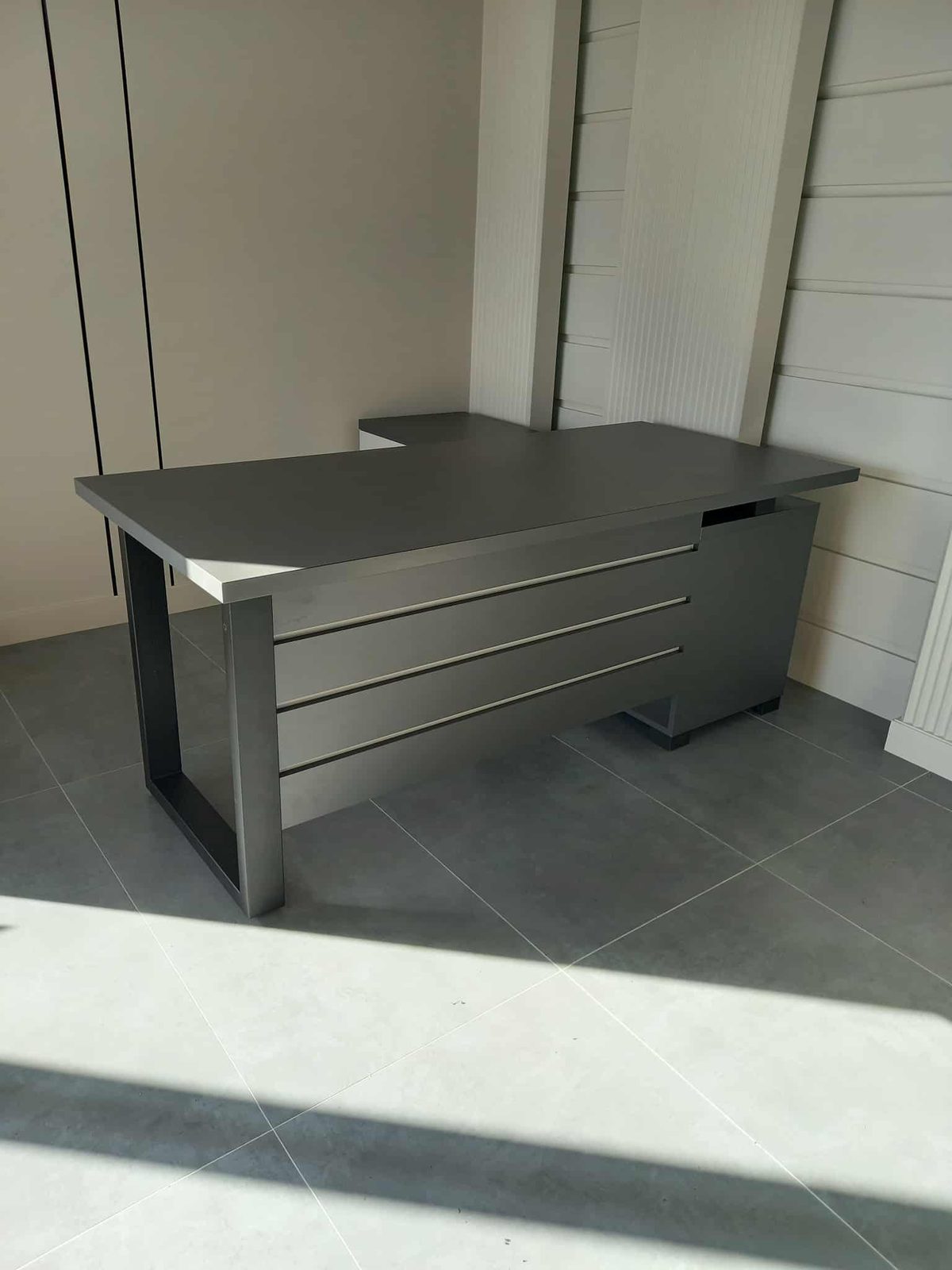 Grey office desk with a drawer pedestal