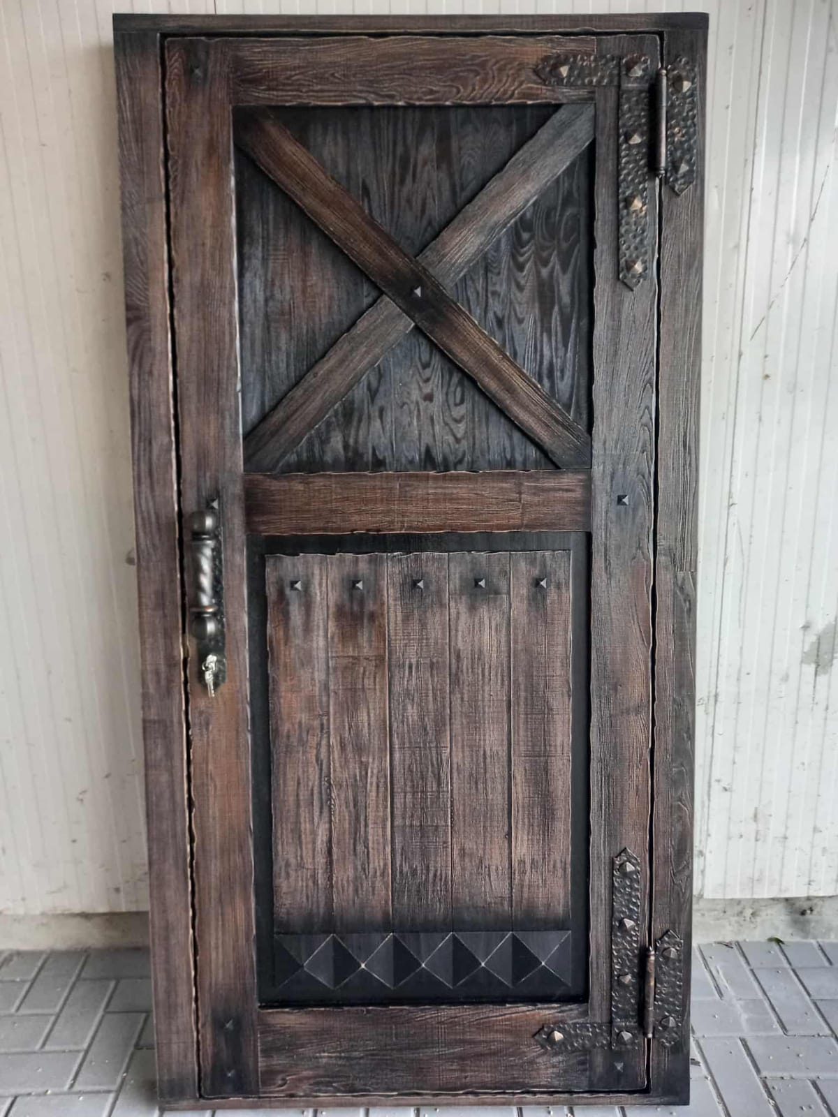 Rustic oak door with forged iron hinges