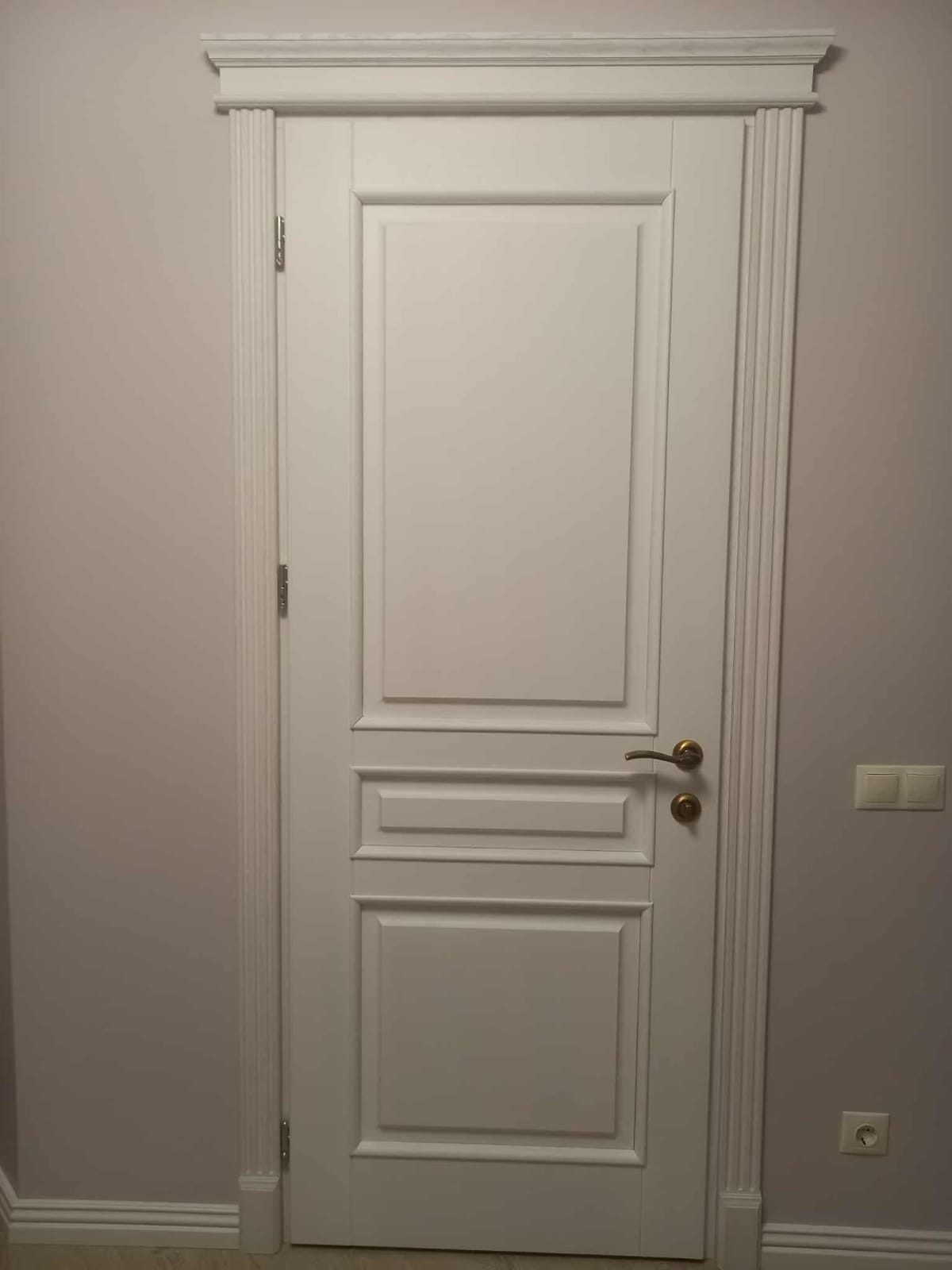 Painted panelled door with architrave