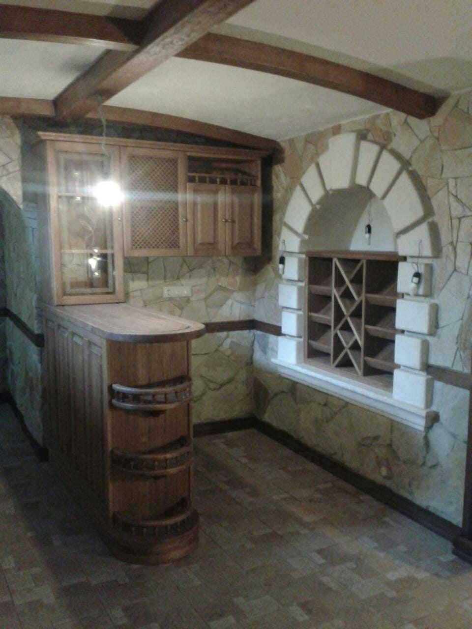 Timber bar counter and cabinets in a stone room