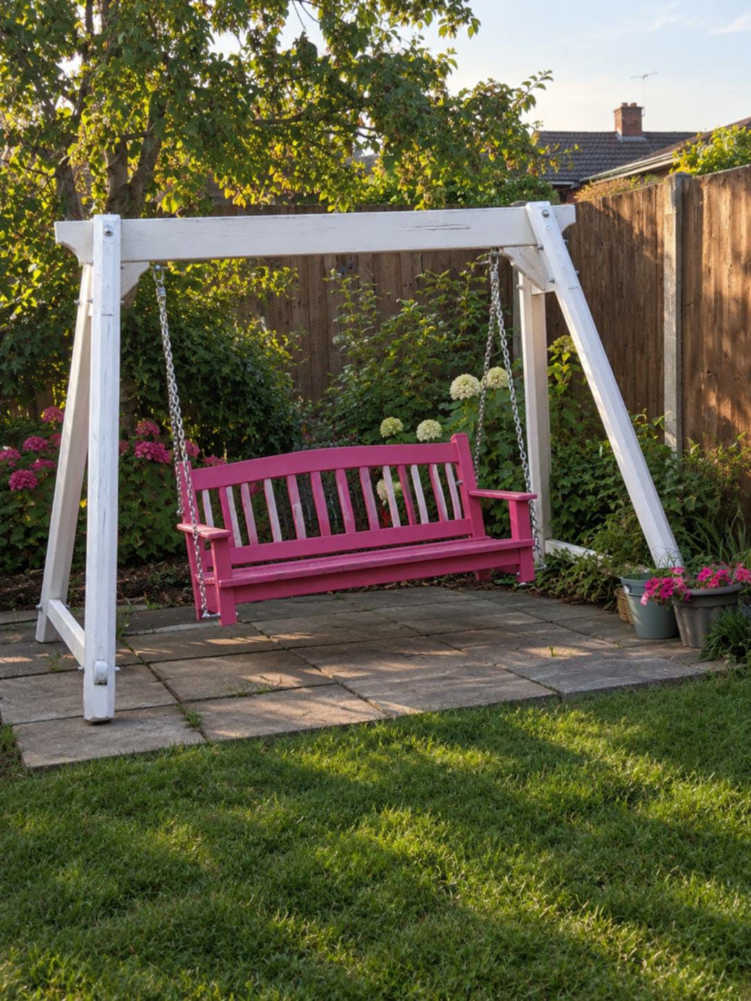 Garden swing seat with a white timber frame
